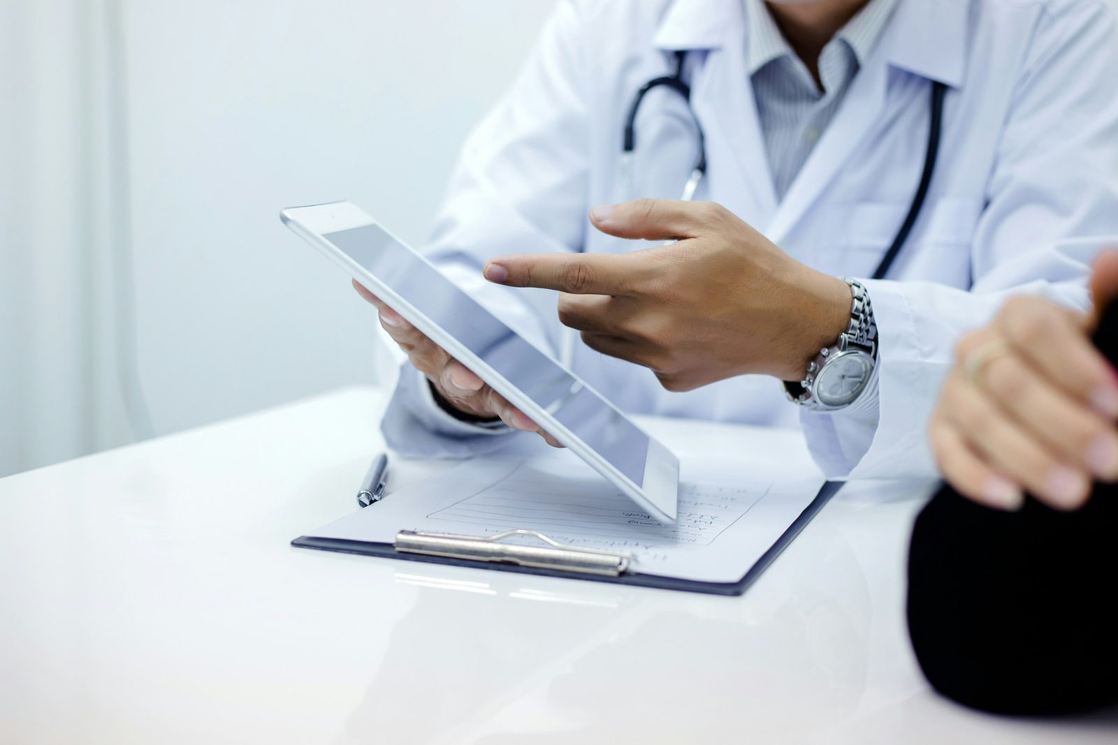 Clinician using healthcare software on a tablet