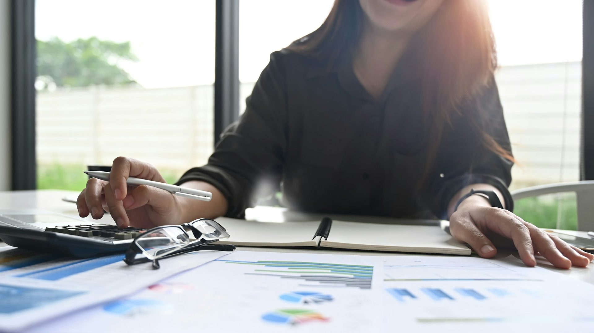 Business owner reviewing financial reports at a desk