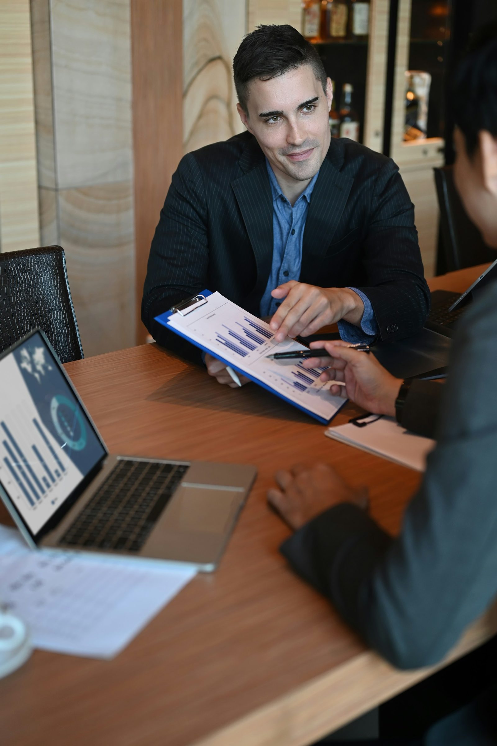CFO and business owner in a working meeting across a table